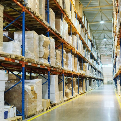 Warehouse racking system with shrink-wrapped pallets organized for high-capacity storage and overflow management